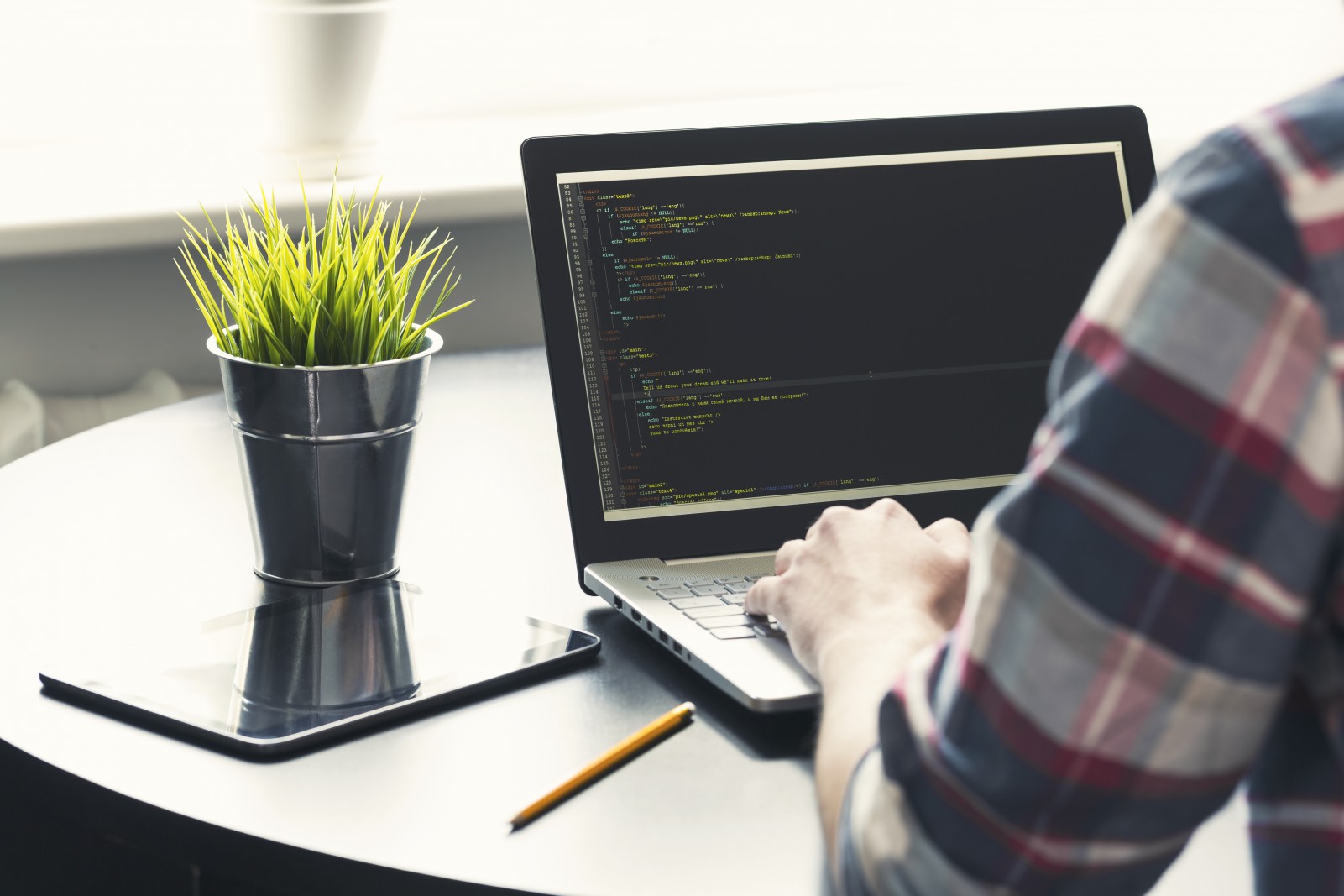 programmer working on laptop at office. focus on programming code